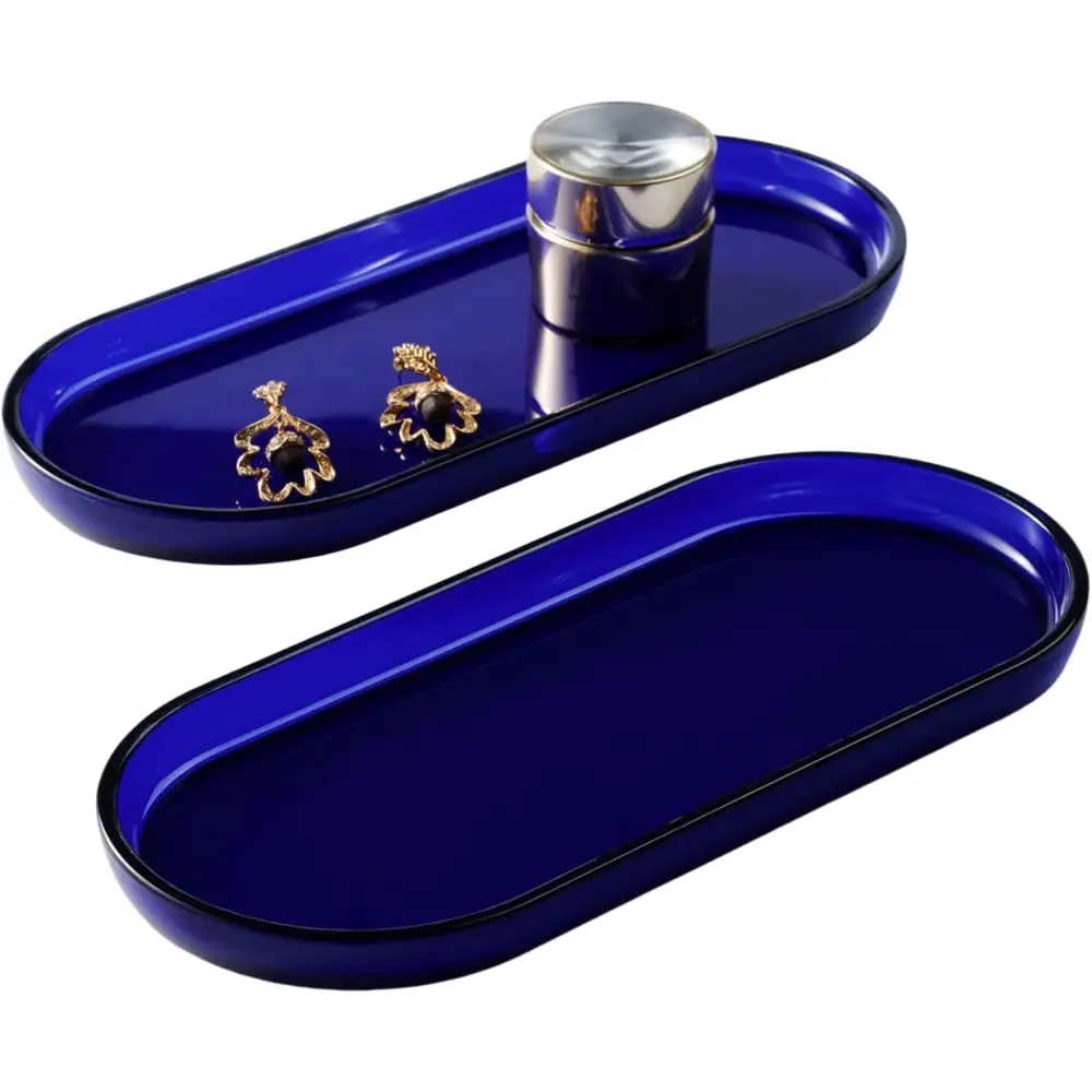 Cobalt blue oval jewelry tray with magnetic closure and gold stud earrings on Brown and Gold Vanity Trays