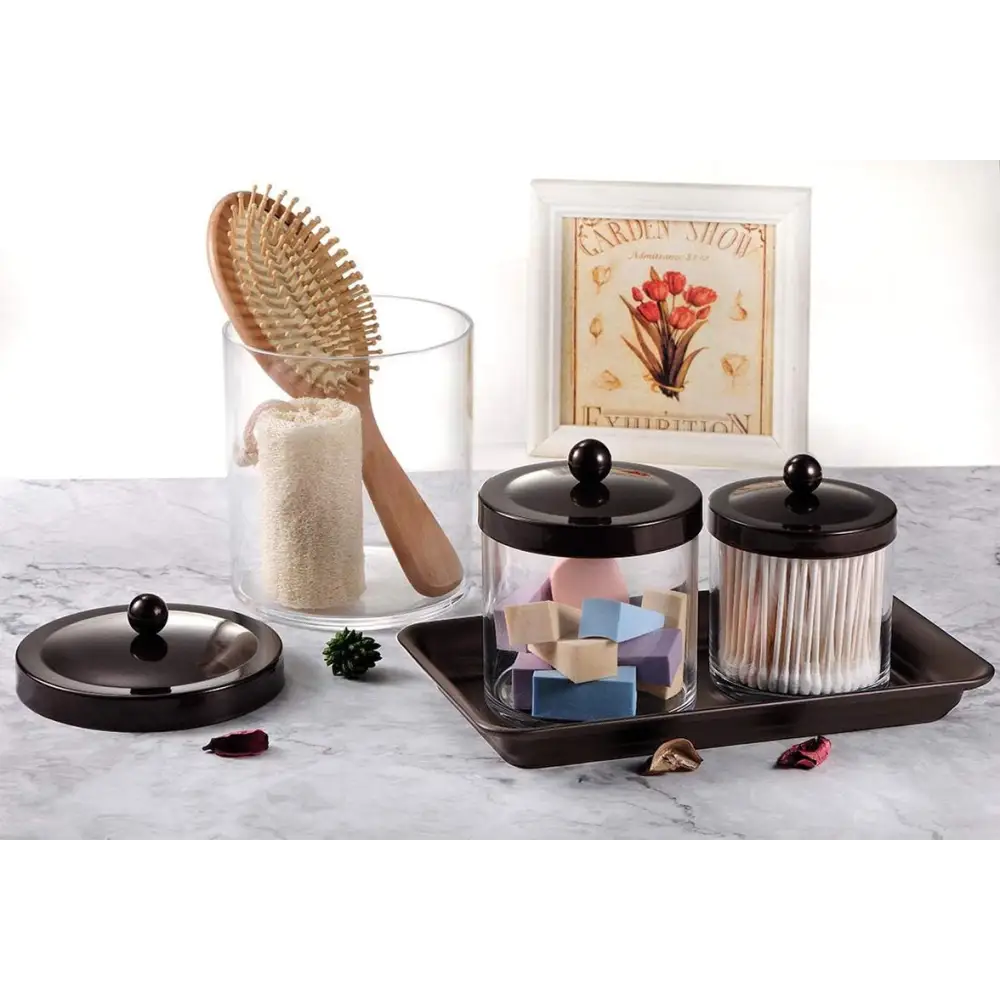 Clear glass jar with black lid and wooden brush in Brown and Gold Vanity Trays with Glass Organizers