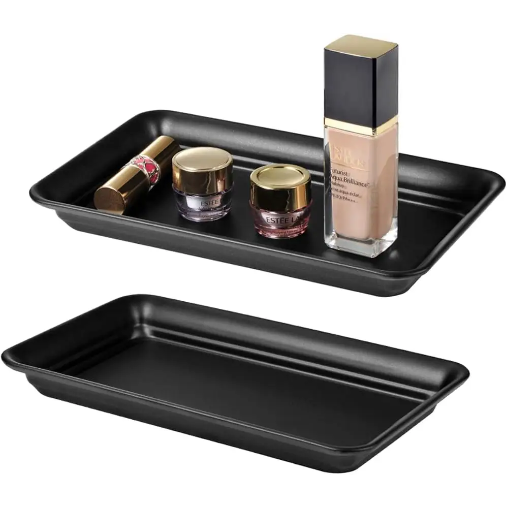 Black matte rectangular vanity tray with gold accents and clear glass cosmetic jars