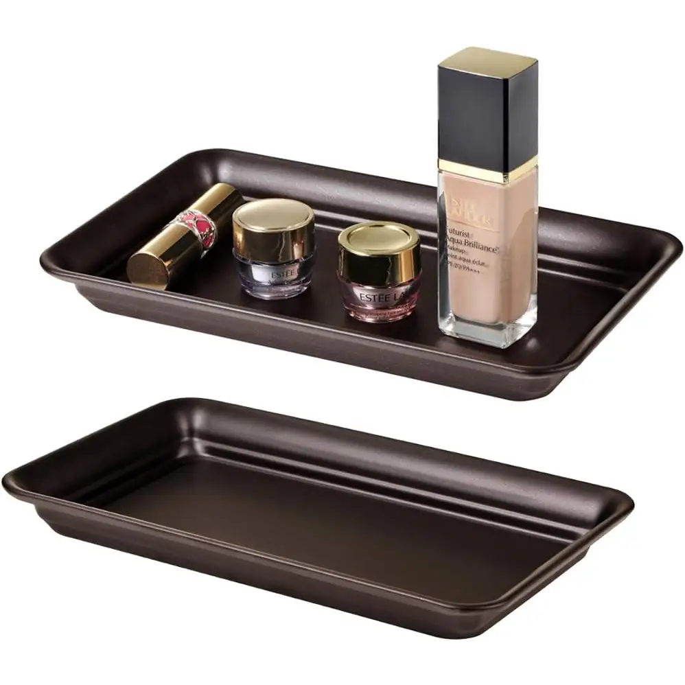 Brown and gold vanity tray with glass containers for makeup storage