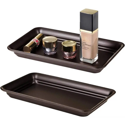 Brown and gold vanity tray with glass containers for makeup storage