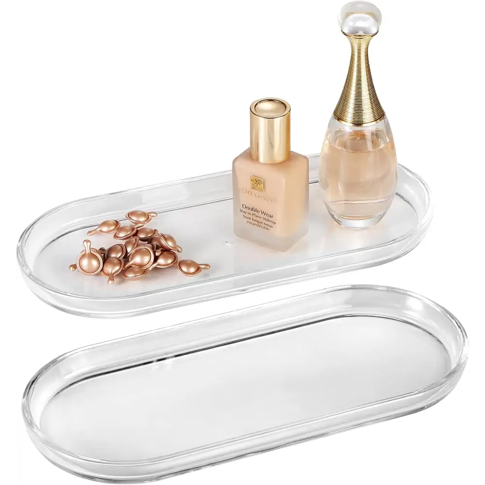 Clear acrylic vanity tray with gold accents and mirrored bottom for makeup or jewelry storage