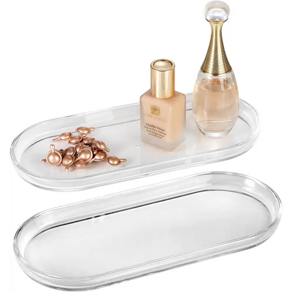 Clear acrylic vanity tray with gold accents and mirrored bottom for makeup or jewelry storage