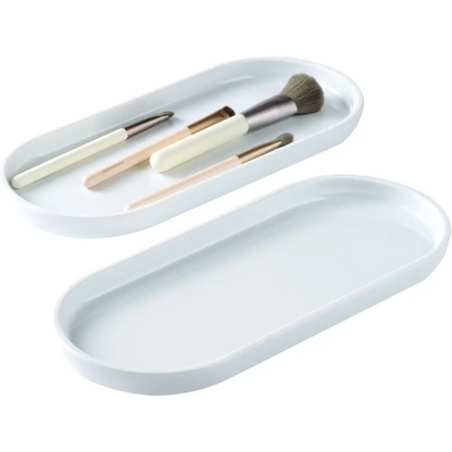 White oval ceramic tray with makeup brushes and mirror from Brown and Gold Vanity Trays