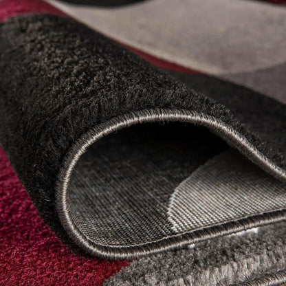 Dark gray textured Circles Abstract Rug with red and black accents in wool or synthetic fiber