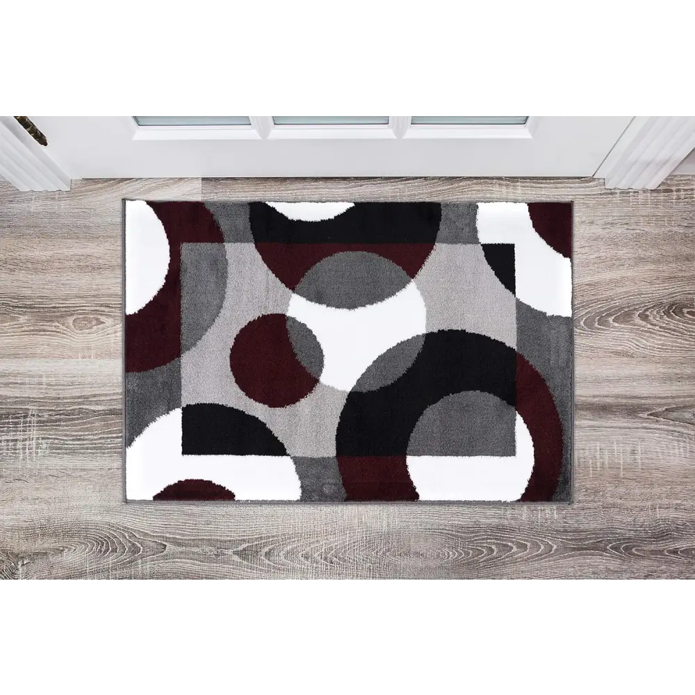 Modern Circles Abstract Rug with circular patterns in burgundy gray and white on dark background