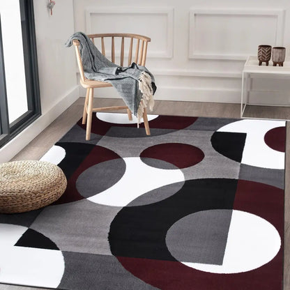 Modern Circles Abstract Rug with large burgundy, black, and white circles on gray background