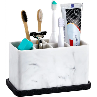 White marble bathroom caddy with black base holding toothbrushes and razor for Marble Toothbrush Holder