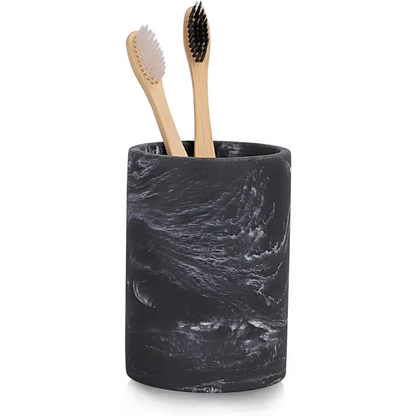 Black marble toothbrush holder with bamboo toothbrushes and white bristles for modern bathrooms