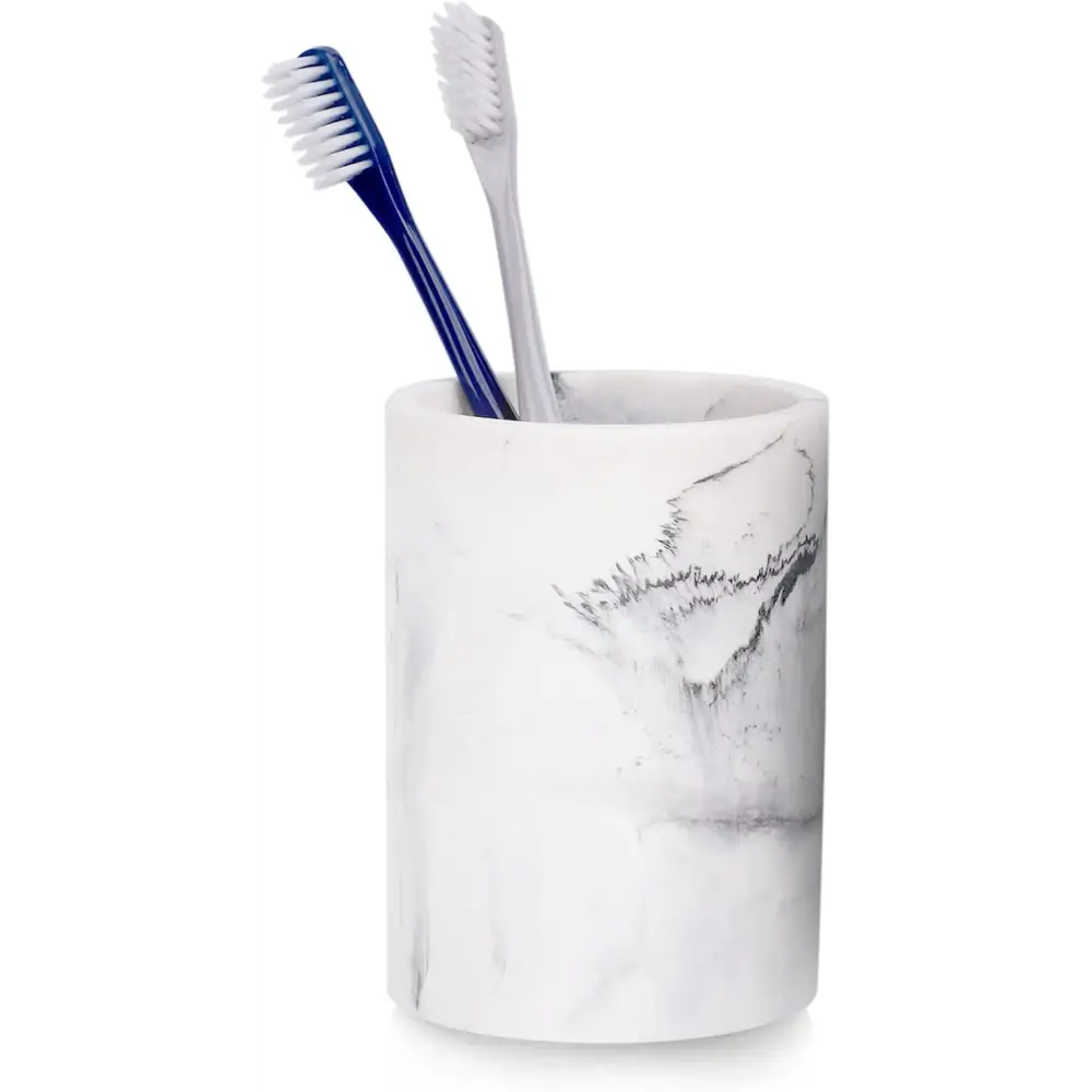 White marble-patterned toothbrush holder with two blue and gray toothbrushes inside