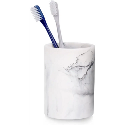 White marble-patterned toothbrush holder with two blue and gray toothbrushes inside