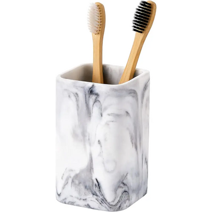 Marble-patterned toothbrush holder with bamboo toothbrushes displayed in a stylish bathroom