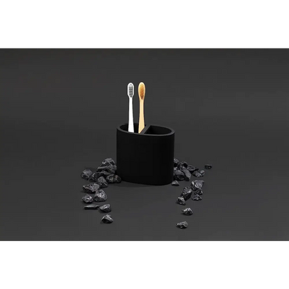 Black matte toothbrush holder set with two brushes, one white and one wooden
