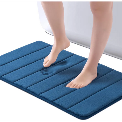 Navy blue ROSMARUS textured memory foam bath mat with non-slip backing for bathroom use