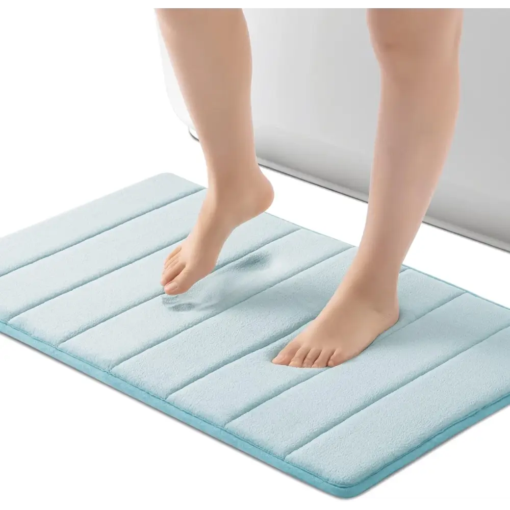 Light blue ROSMARUS Navy textured memory foam bath mat with non-slip backing