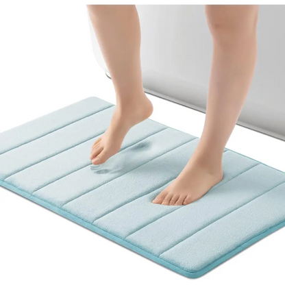 Light blue ROSMARUS Navy textured memory foam bath mat with non-slip backing