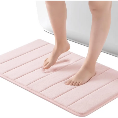 Pink plush bath mat with textured stripes and non-slip backing from ROSMARUS Navy collection