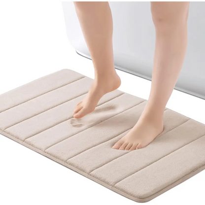 Beige quilted memory foam bath mat with textured surface and non-slip backing
