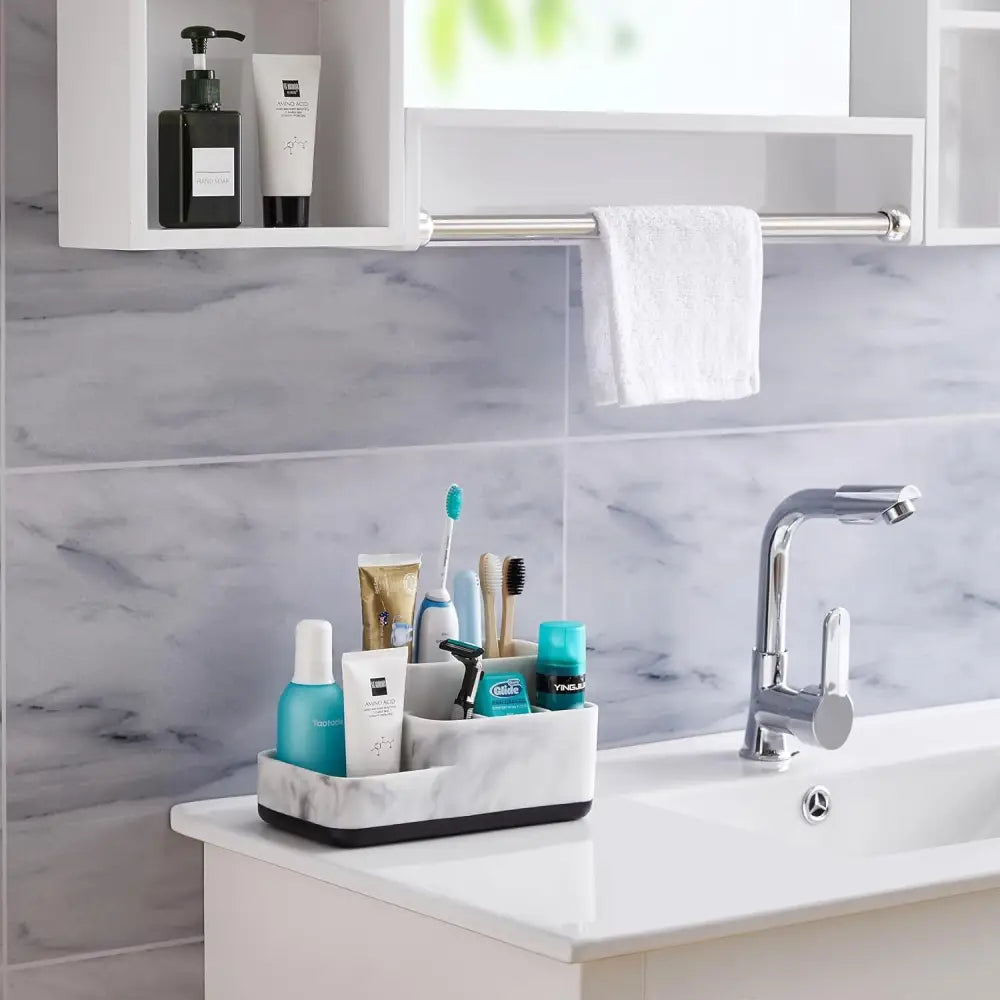 Black and white striped toothbrush holder with compartments for bathroom essentials